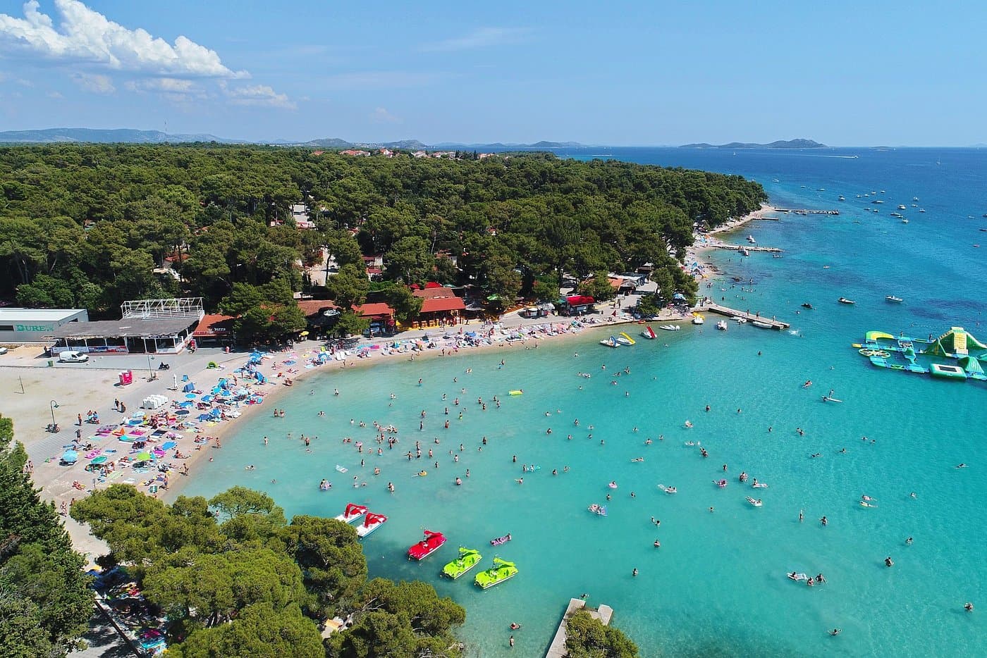 Soline Beach in Biograd with pine trees and shallow waters
