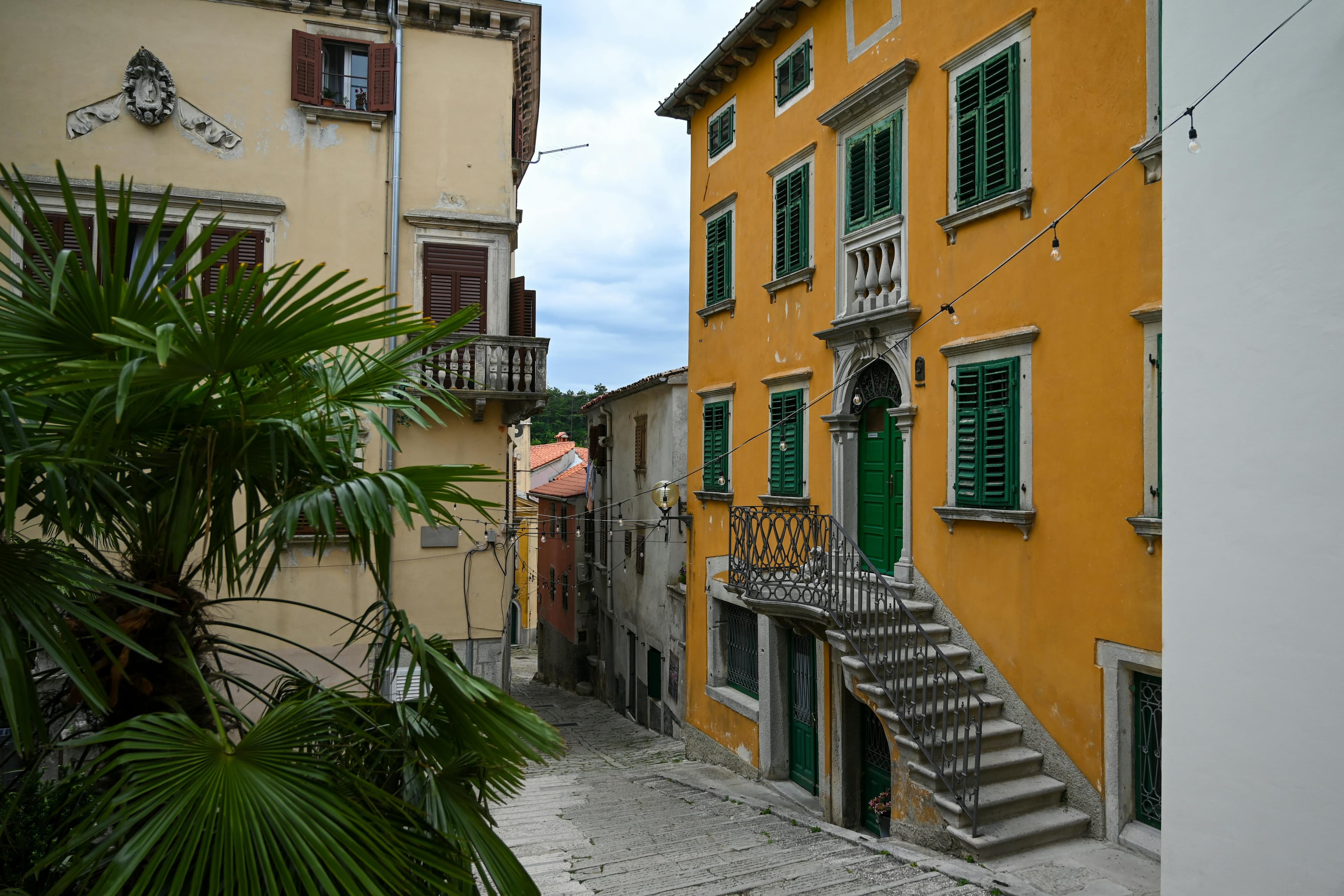Narrow Venetian stone street in Labin's old town with galleries and stone buildings