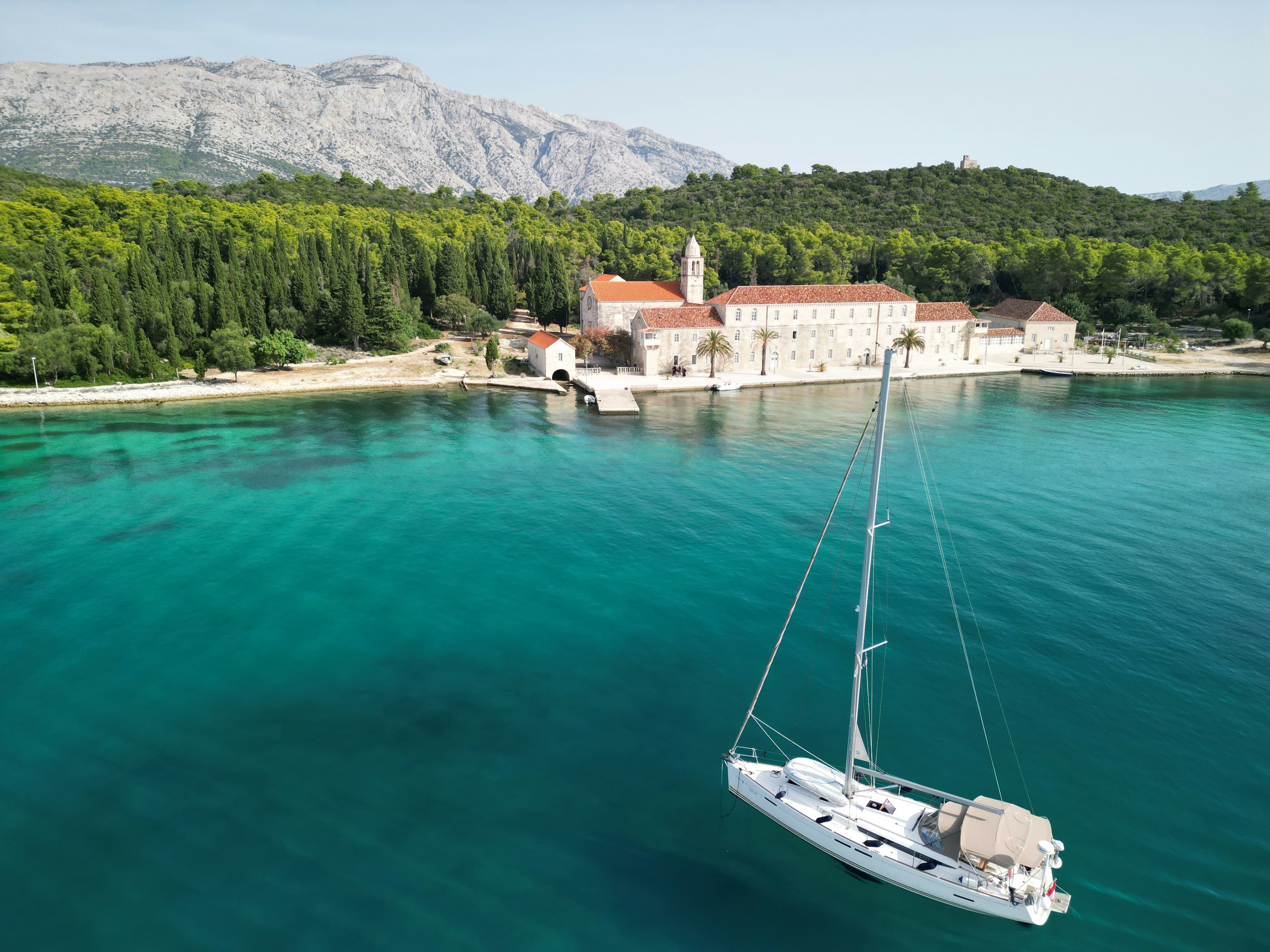 Sailing boat passing Badija island near Korčula in southern Dalmatia, Croatia