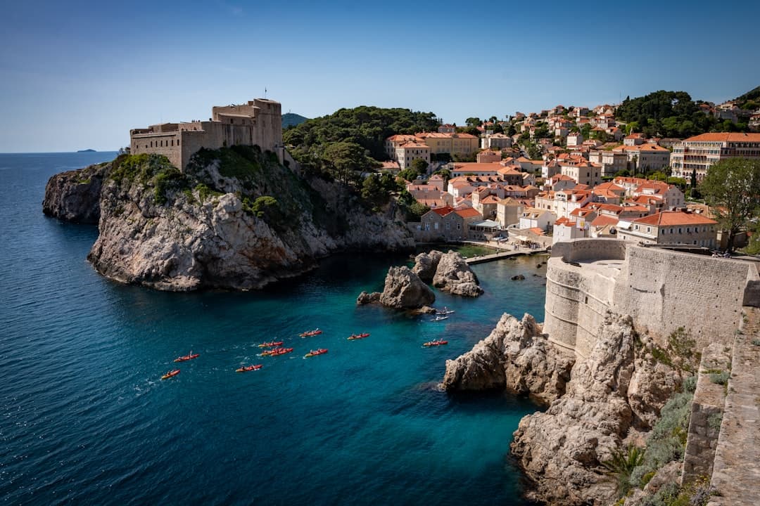 Kayakers passing beneath Lovrijenac fortress in Dubrovnik, on the standard route from Pile Gate to Lokrum island.