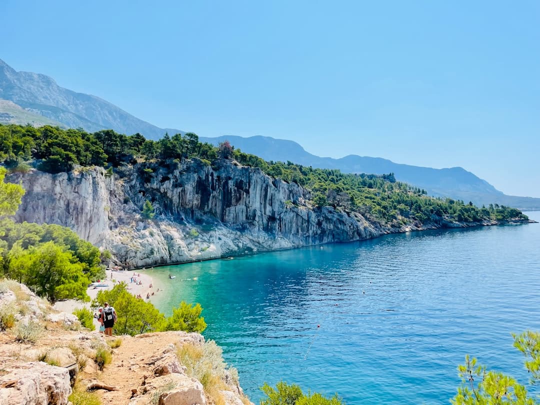 White limestone cliffs above turquoise Adriatic water on Dugi Otok, with pine-covered slopes — the signature scenery of Telašćica Nature Park.
