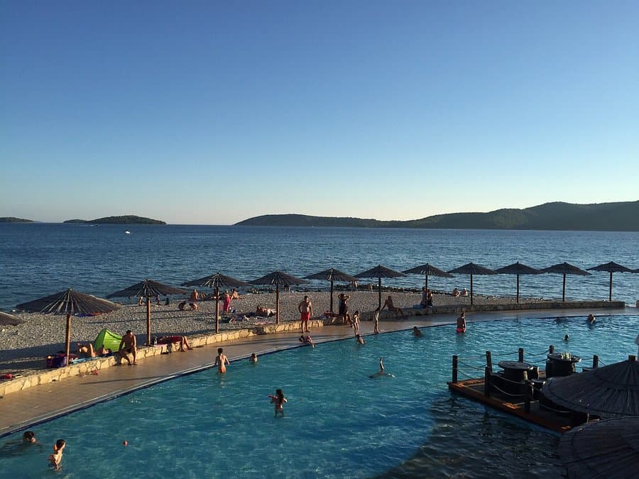 Croatian family resort pool cluster — hotel pools and beach facilities on the Adriatic coast